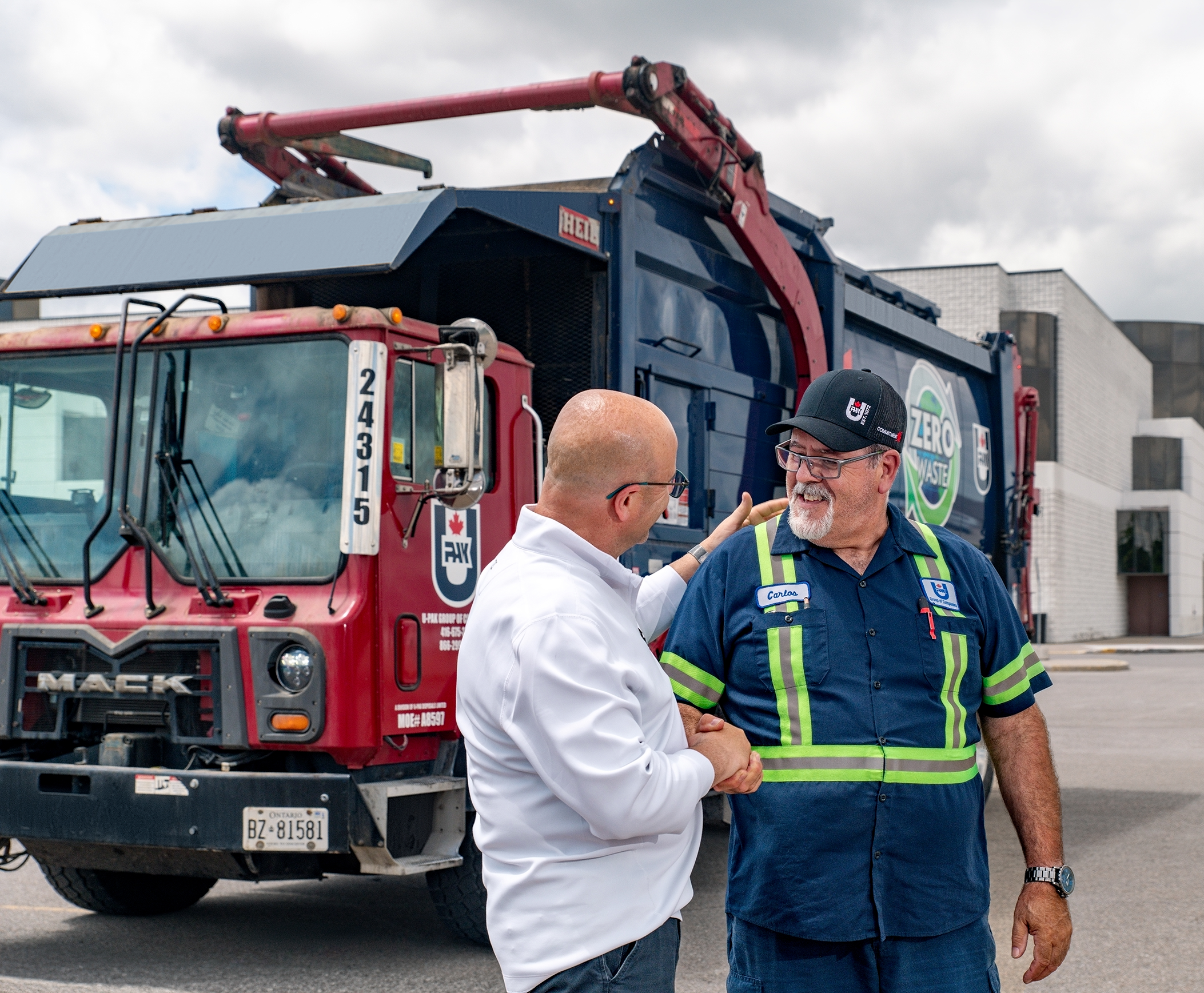 FRONT-LOADER_013-web U-Pak truck driver shaking hands image. U-Pak offers R100 renewable diesel fuel to our fleet operations, in order to improve our sustainability initiatives and to continue to provide our clients reliable service.